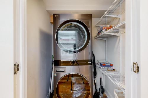 a washer and dryer in a room with shelves at Town of Rehoboth Beach 24 Rehoboth Ave in Rehoboth Beach