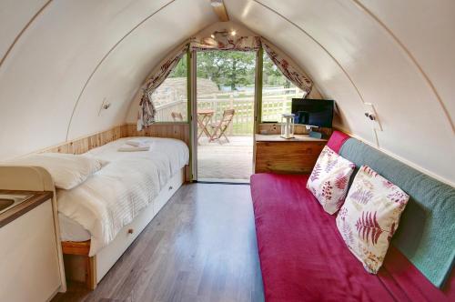 a bedroom with a bed and a couch in a room at Finest Retreats - Humbleton Glamping in Hexham
