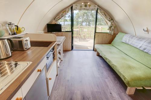 a kitchen with a couch in a tiny house at Finest Retreats - The Wonneys Glamping in Hexham