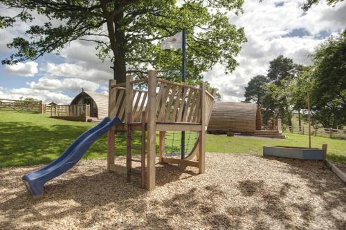 a playground with a slide in a park at Finest Retreats - Wheatleys Glamping in Hexham