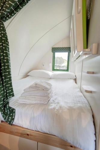 a room with a bed with white sheets and a window at Finest Retreats - The Rushy Lot in Hexham