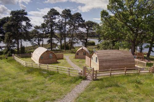 a group of huts in a field next to a fence at Finest Retreats - The Rushy Lot in Hexham