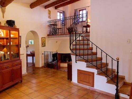 a hallway with a spiral staircase in a house at Les Alouettes Hikers, Bikers and Wine Lovers Paradise in Malaucène