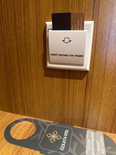 a register on a wooden table with a box on it at Özkaya hotel in Sivas
