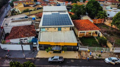 an overhead view of a house with a solar roof at Hotel Amadeu´s in Cuiabá