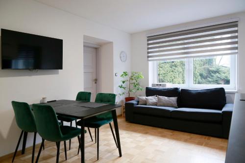 a living room with a table and a couch at Aparthotel Brokeš in Lanškroun
