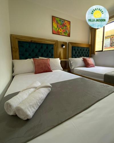 a bedroom with two beds with towels on them at Villa Jackson in La Tebaida