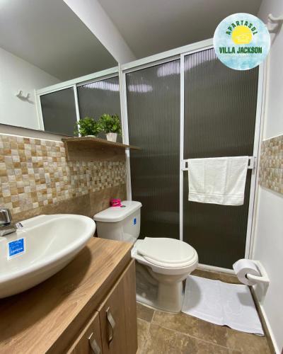 a bathroom with a toilet and a sink and a shower at Villa Jackson in La Tebaida