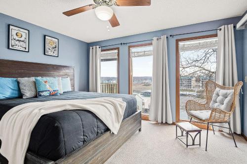 a bedroom with blue walls and a bed and a chair at Full Moon Condo in Lake Ozark
