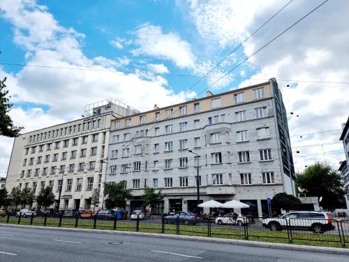 a large white building on the side of a street at Noclegi Stadion Bed & Breakfast in Warsaw