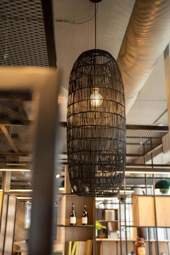 a pendant light hanging from the ceiling in a room at Ibis Bourgoin Jallieu Medipole in Bourgoin