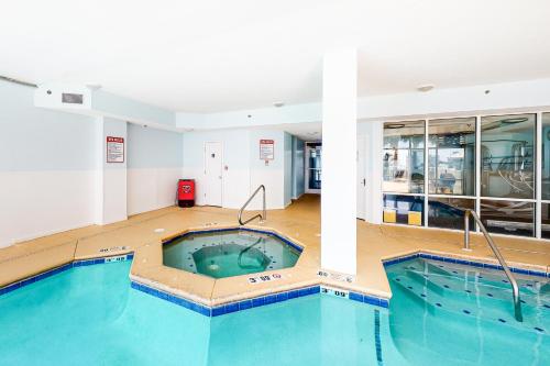 a large swimming pool in the middle of a building at The Dunes 704 in Gulf Shores