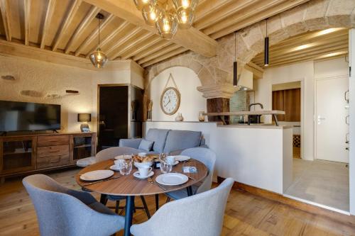 a kitchen and dining room with a table and chairs at Le Balcon Perrière I - Charming apartment with direct view of the Thiou in Annecy