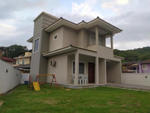 a house with a playground in front of it at Casa Excepcional na Praia Brava - Florianópolis in Florianópolis