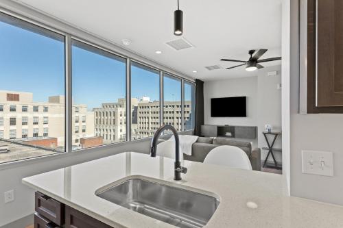 a kitchen with a view of a living room at 175 LEX - Walkable Downtown Lexington & Rupp Arena - Full Condos in Lexington