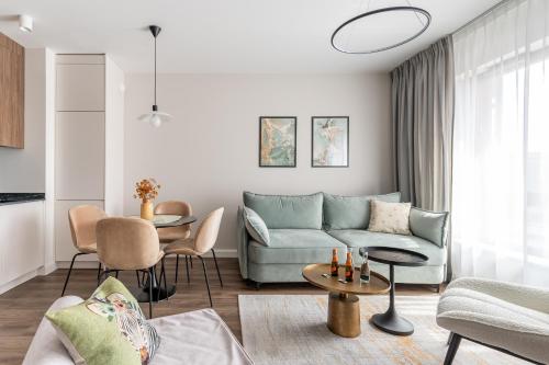 a living room with a couch and a table at Lion Apartments - SCALA City Center Apartments&Parking IA in Gdańsk