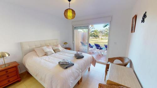 a bedroom with a bed and a table and chairs at Casa Abeto A - Murcia Holiday Rentals Property in Torre-Pacheco