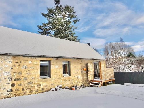 a stone house in the snow with a tree at The Bakehouse - by Where Stags Roar in Newtonmore