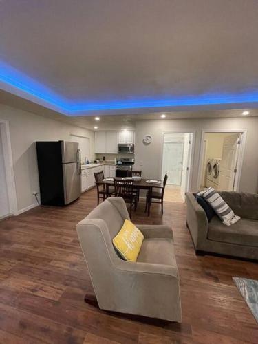 a living room with a couch and a table in it at Brand New 2BR CUTE Blue LED in North Fresno in Fresno