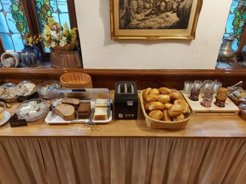 a buffet with bread and pastries on a table at Hotel Weinhaus Am Stiftstor in Treis-Karden