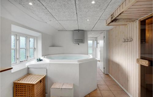 a large white bathroom with a tub in it at 8 Bedroom Beautiful Home In Hjer in Højer