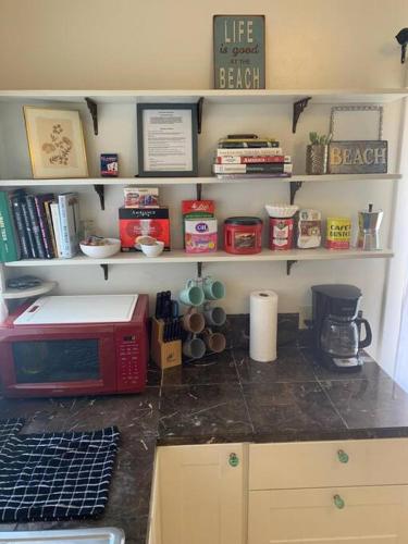 a kitchen counter with a red microwave on a counter top at Ruth House Original Craftsman PETS, walk to State st. in Santa Barbara