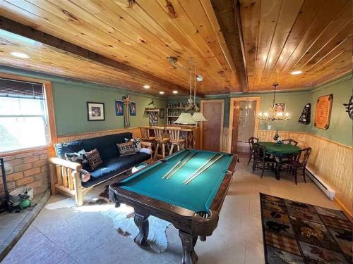 a living room with a pool table in it at Close to skiing and hiking, walk to main street in Tannersville