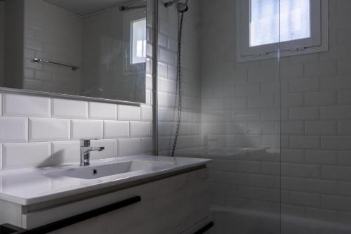 y baño blanco con lavabo y ducha. en Apartment Manilva, en Manilva
