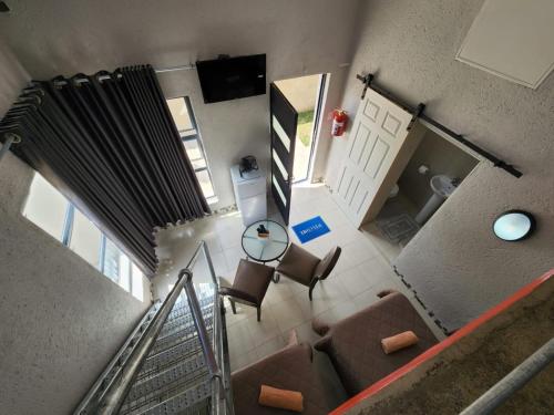 an overhead view of a living room with a staircase at 9 Levubu Cottages in Polokwane