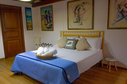 a bedroom with a large bed with a blue table at Villa Carla in Cinisi