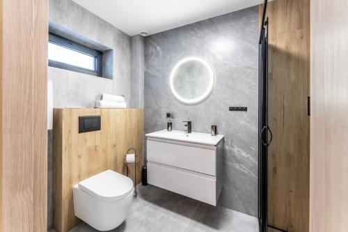 a bathroom with a white toilet and a sink at Domki Słoneczna 11 z widokiem na Śnieżkę in Karpacz