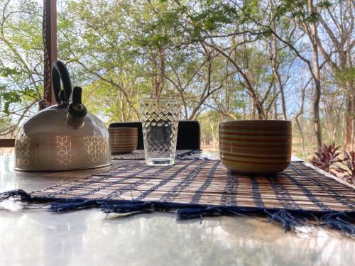 a table with a tea pot and cups on it at CASA NATURaL in Brasilito