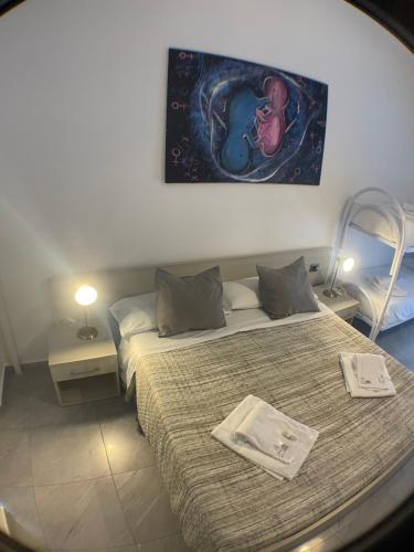 a bedroom with two beds and a painting on the wall at Il vecchio Fauno in Pompei