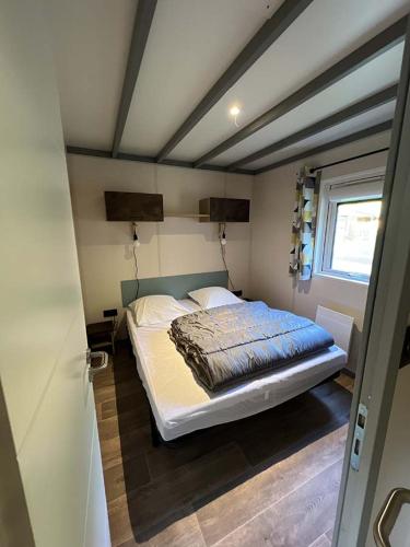 a bedroom with a large bed in a room at Camping La Ferme de Castellane in Castellane