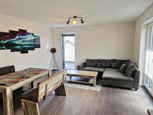 a living room with a couch and a table at DM Hotes & Apartments - Apartment Rasenweg in Dingelstädt