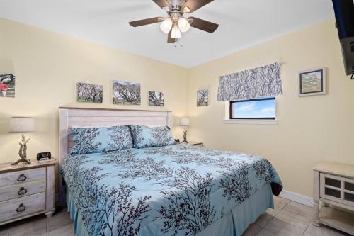 a bedroom with a bed and a ceiling fan at Laguna Reef #410 - BraveWave in Rockport