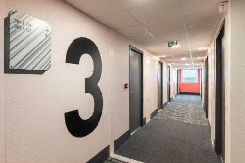 a hallway with a number on the wall at B&B HOTEL Bourg-en-Bresse Viriat in Viriat