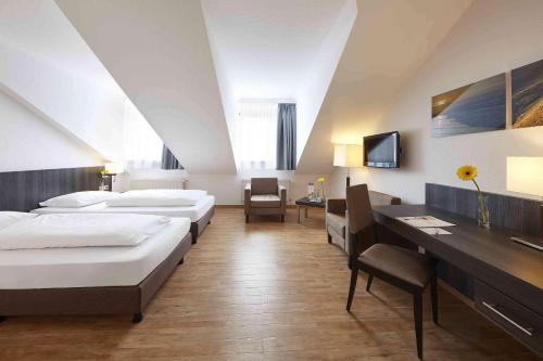 Ένα ή περισσότερα κρεβάτια σε δωμάτιο στο GHOTEL hotel & living Kiel