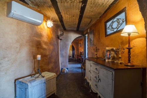a hallway with a dresser and a lamp in a room at Charming Villa in Algarinejo with Private Pool in Algarinejo