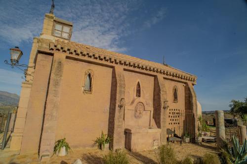 an old church with a tower on the side of it at Charming Villa in Algarinejo with Private Pool in Algarinejo