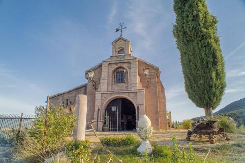 an old church with a cross on top of it at Charming Villa in Algarinejo with Private Pool in Algarinejo