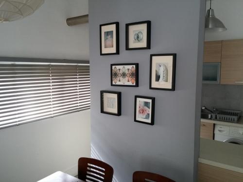 a kitchen with four framed pictures on a wall at The Kapitani Residence in Nicosia