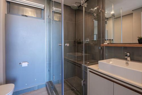 a bathroom with a shower and a sink at Umhlanga Arch Luxury Holiday or Work with Sea View - Inverter Backup Power in Durban