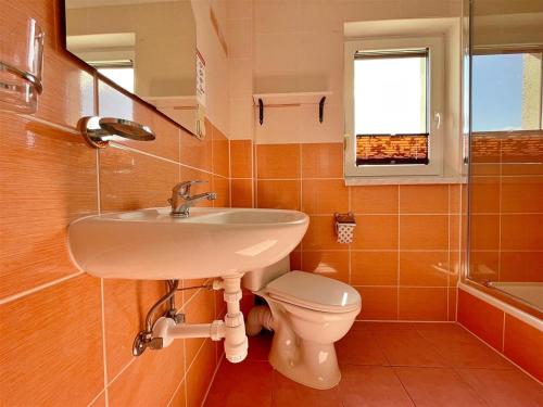 a bathroom with a sink and a toilet at TOPOLA in Gąski