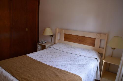 a hotel room with a bed and two lamps at Rincon del Este Resort in Punta del Este