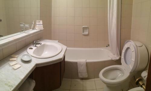 a bathroom with a sink and a toilet and a tub at Rincon del Este Resort in Punta del Este