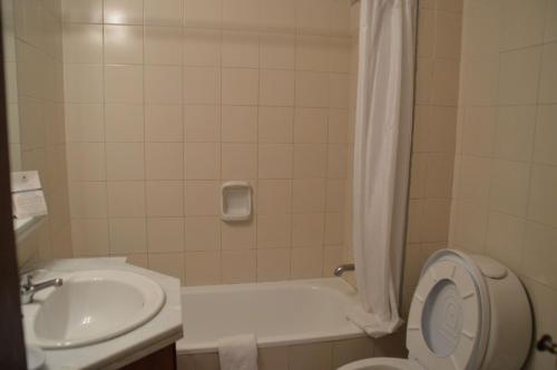 a bathroom with a sink and a toilet and a tub at Rincon del Este Resort in Punta del Este