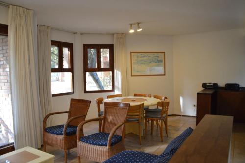 a dining room with a table and chairs at Rincon del Este Resort in Punta del Este