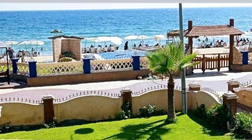 a view of the beach from a resort at Renovated super Lux Apartment Chalet Direct sea view 2 bed rooms in Alexandria Al Mamourah شاليه الترا لوكس شاطىء المعموره الاسكندريه دور اول على البحر مباشره مع كارنيهات الدخول طوال السنه و الشاطىء الخاص من اول مايو لنهايه اكتوبر للعائلات فقط in Alexandria
