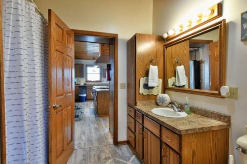 a bathroom with a sink and a mirror at Bark Point Retreat in Herbster